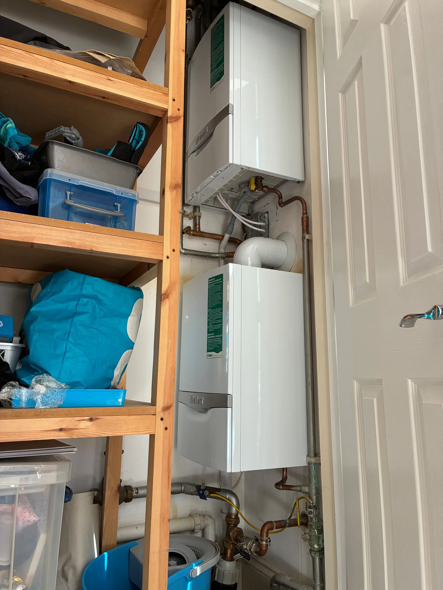 Twin Vaillant boilers fitted in a utility cupboard