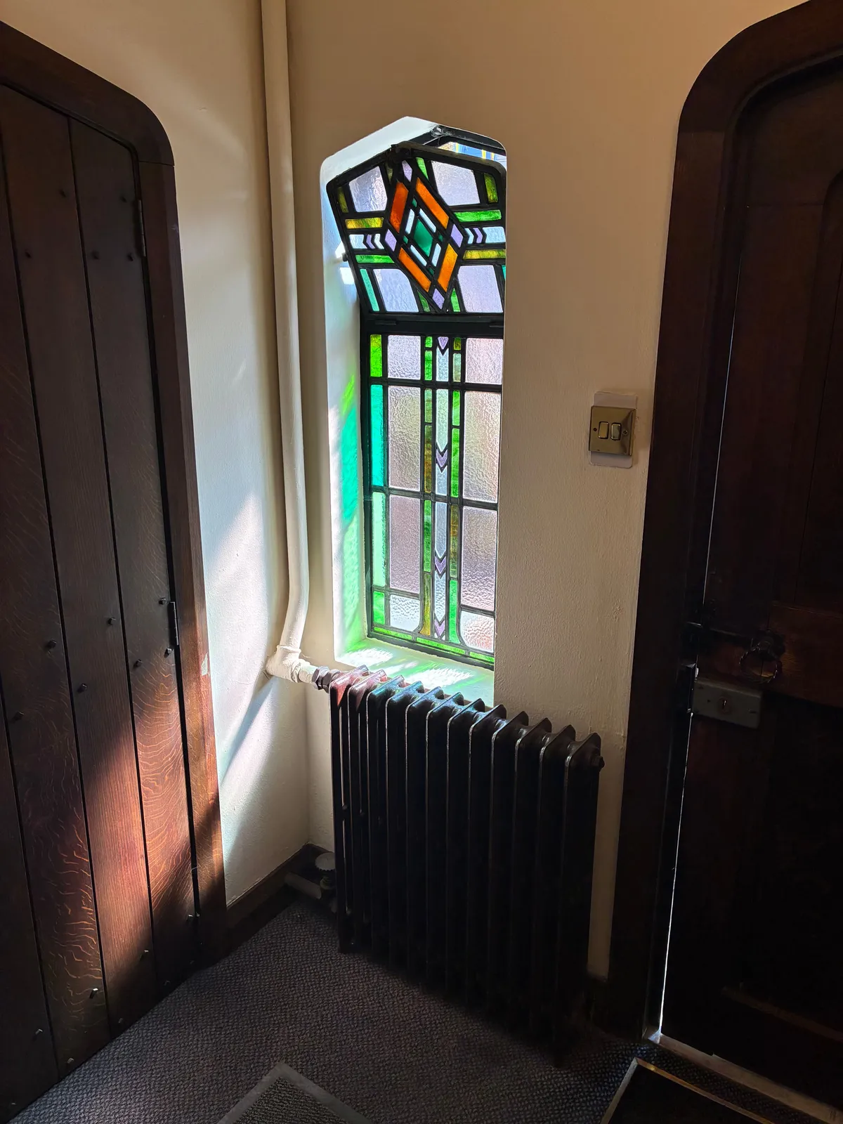 Old cast-iron column radiator from the original system being replaced
